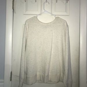 cream colored sweatshirt with touches of color